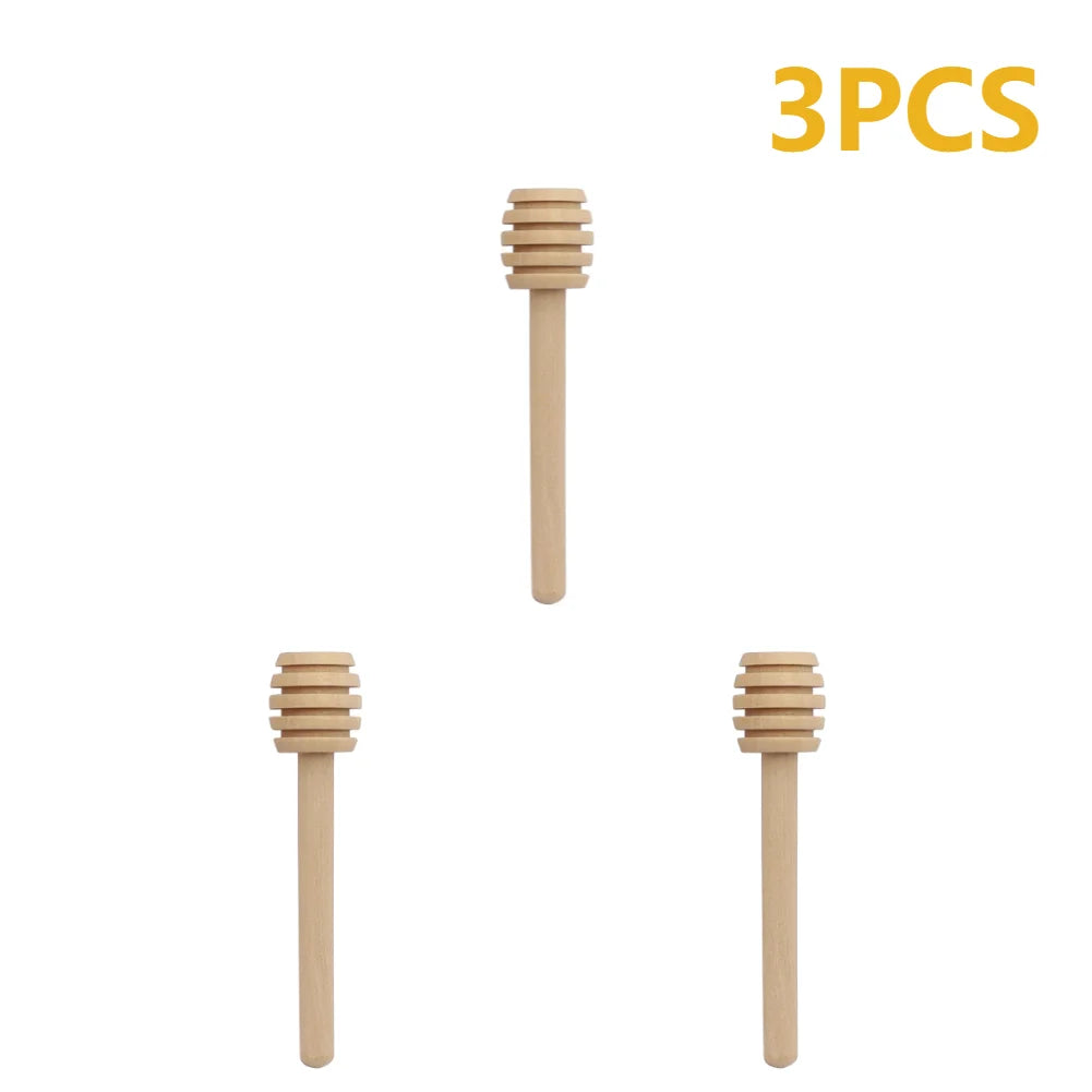 Three natural wood honey dipper sticks shown vertically.