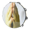 A close-up view of a wooden hand tambourine with steel jingles, showing hands pressed together in a prayer gesture.