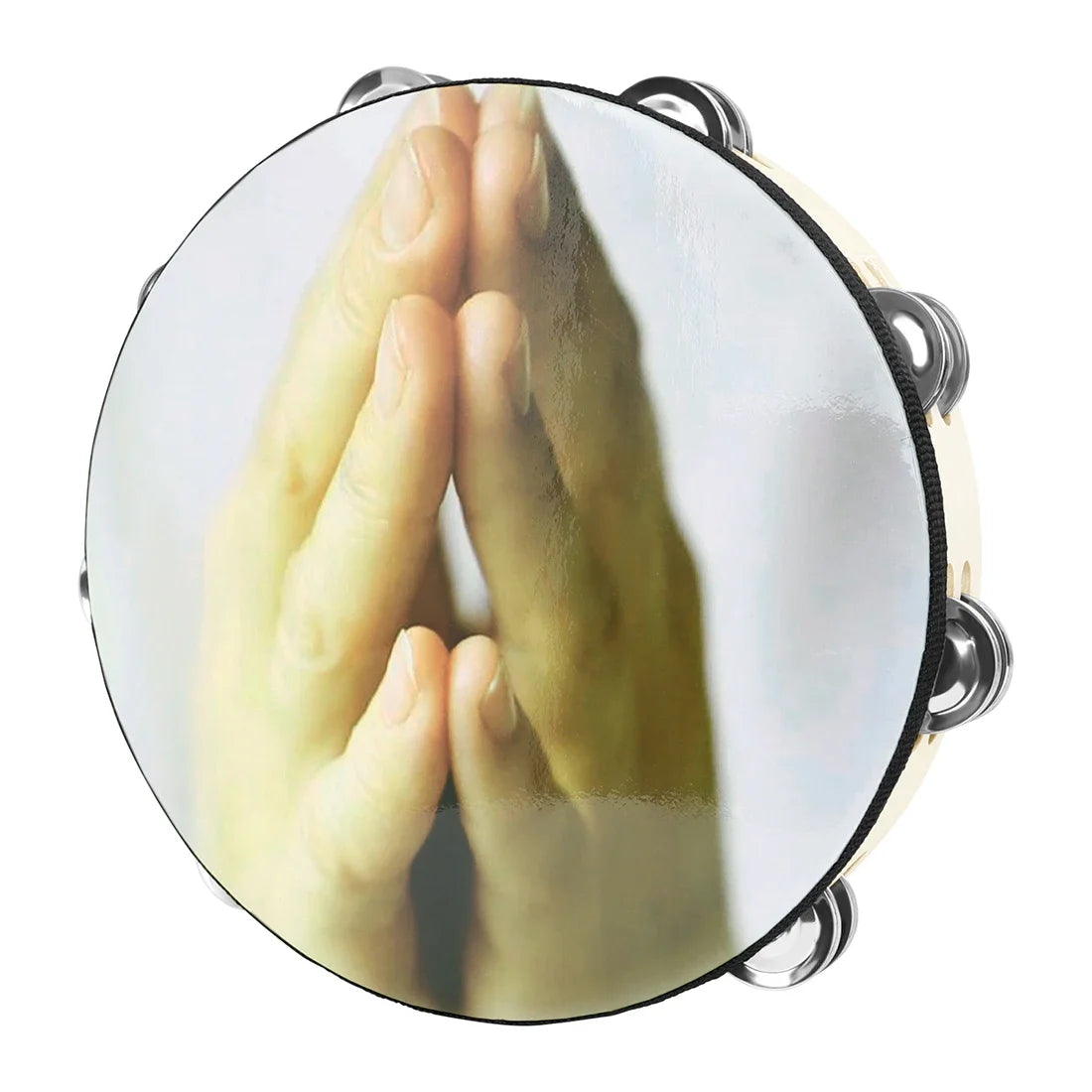 A close-up view of a wooden hand tambourine with steel jingles, showing hands pressed together in a prayer gesture.