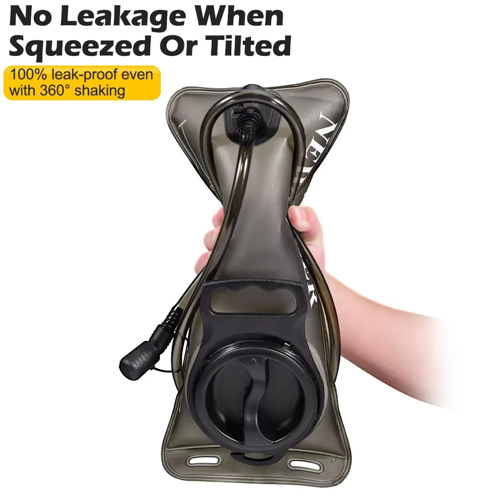 A hand is squeezing a flexible, collapsible hydration bladder designed for leak-proof use.