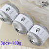 A pile of 20 spools of silver glitter yarn is displayed on a light surface.