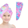 A pink microfiber hair drying towel wrap featuring a vibrant unicorn pattern with purple and pink hues.