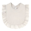 A light beige soft cotton baby bib in a bandana style with ruffled edges.