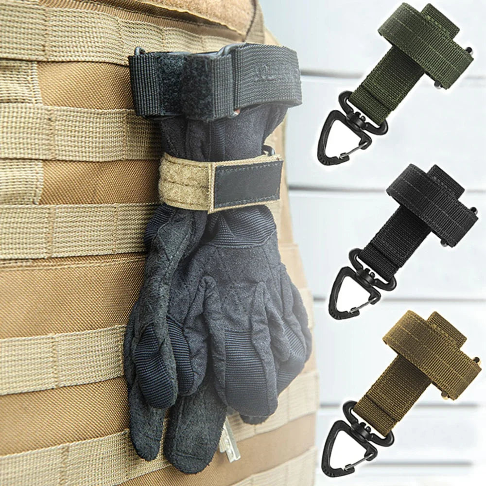 A pair of dark gray nylon gloves with adjustable clips are shown hanging on a beige woven strap.