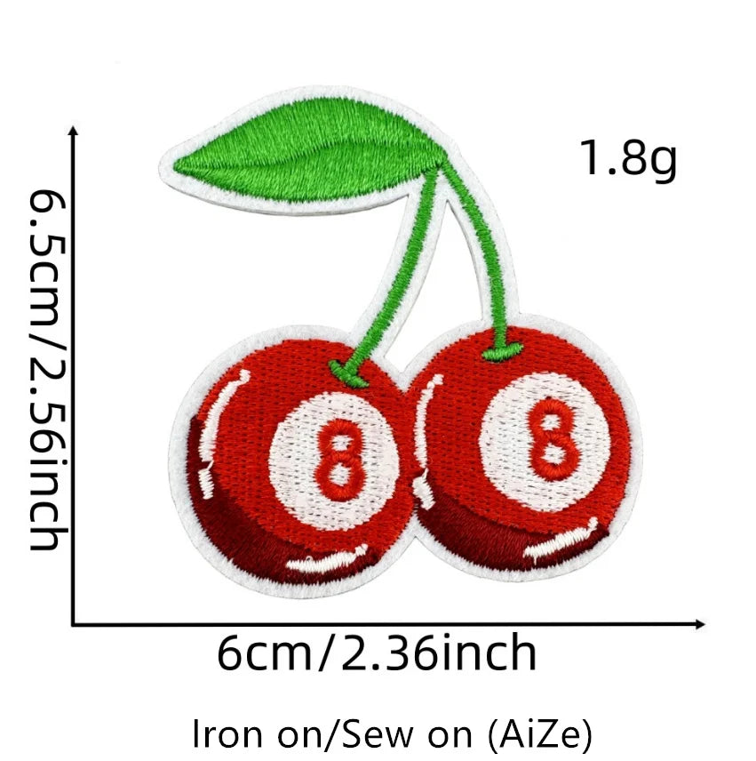 A green cherry embroidery patch with a red fruit design, measuring 1.8g.