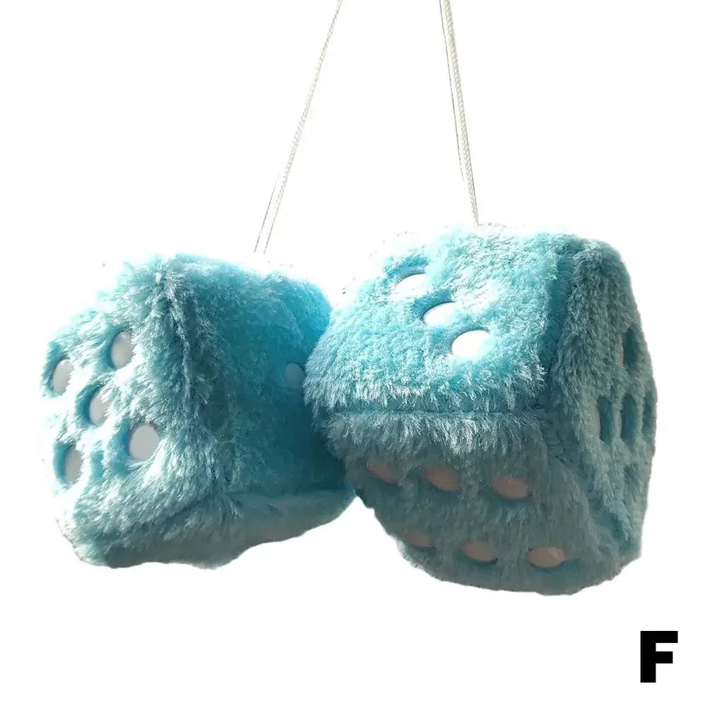 A turquoise plush velvet dice car mirror pendant hanging from a string.