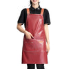 A woman wearing a red leather kitchen apron with multiple pockets over a black shirt.