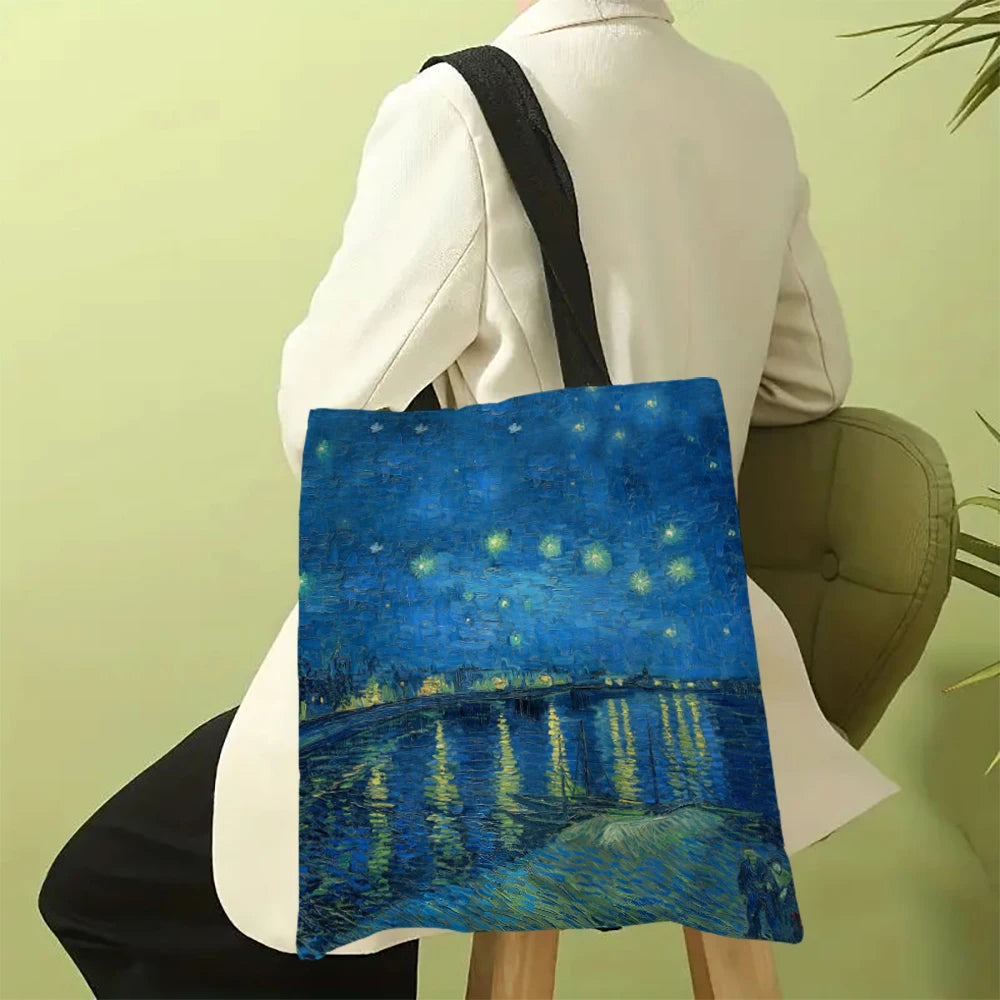 A canvas tote bag featuring a blue night sky with bright yellow stars and a reflection of water.