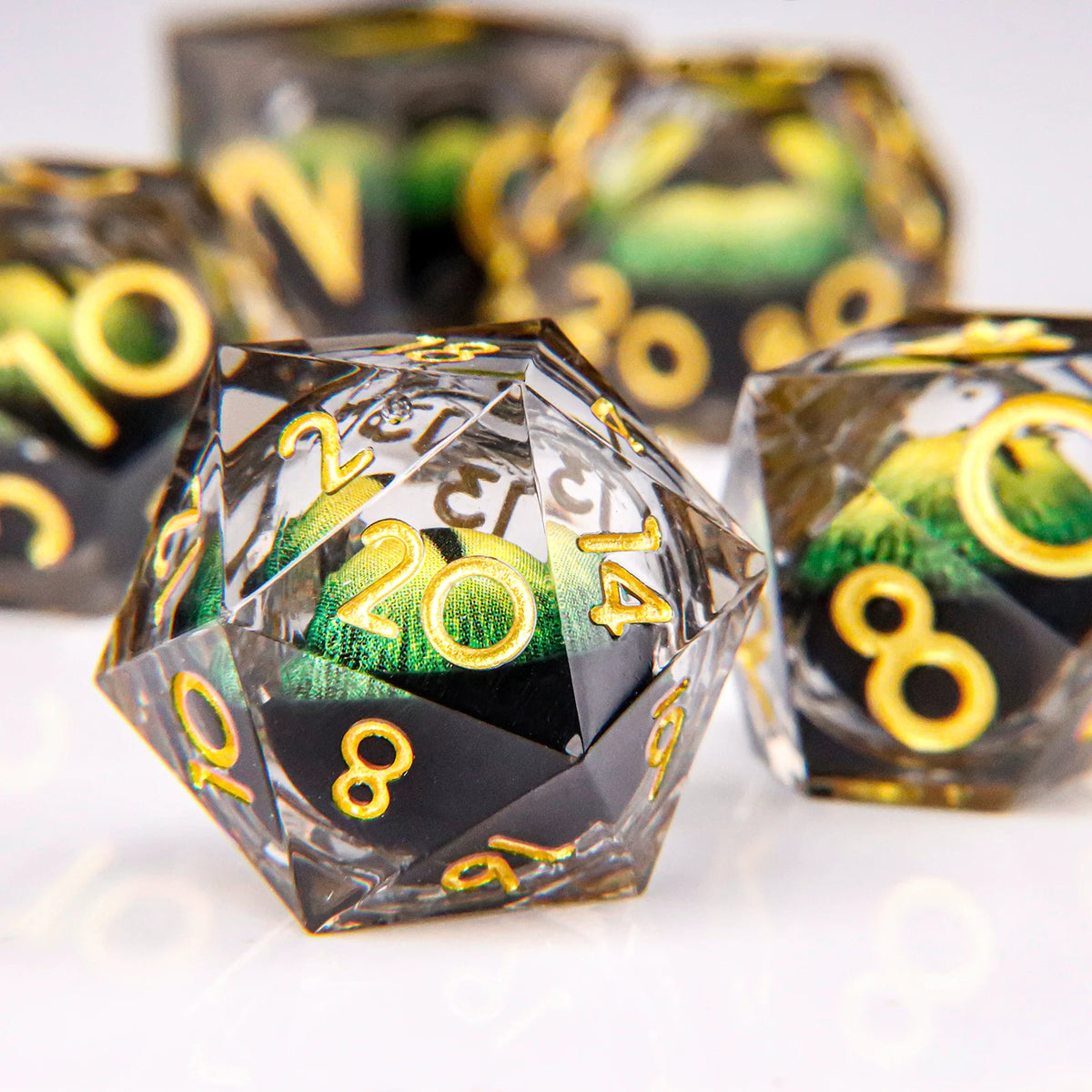 A close-up of a set of liquid core resin dice featuring a dragon eye design, showing various numbers and colors.