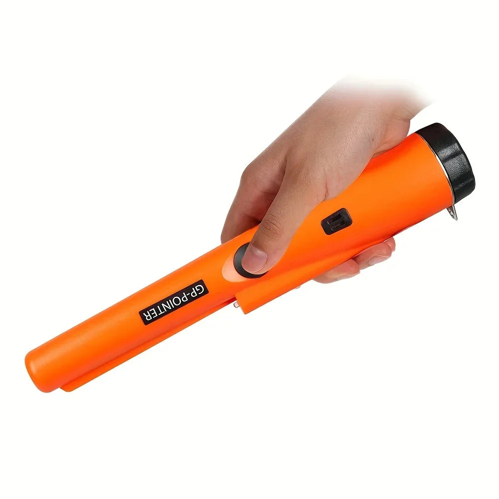 A hand is holding an orange GP-Pointer handheld metal detector with a black grip.