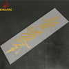 A silver motorcycle helmet sticker featuring yellow wildstyle graffiti text on a dark background.