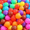 A pile of colorful, non-toxic ball pit balls in various bright colors like red, orange, yellow, green, and purple.