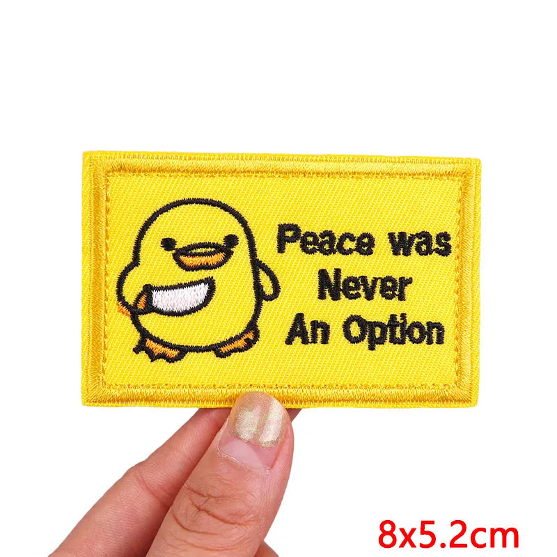 Yellow embroidered patch featuring a cartoon chick with the text Peace was Never An Option