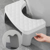 A white ergonomic non-slip toilet squat stool with a diamond-patterned seat and a smooth, modern design.