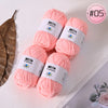 Pink Milk Cotton yarn skeins in various sizes and a loose leaf are displayed on a white background.