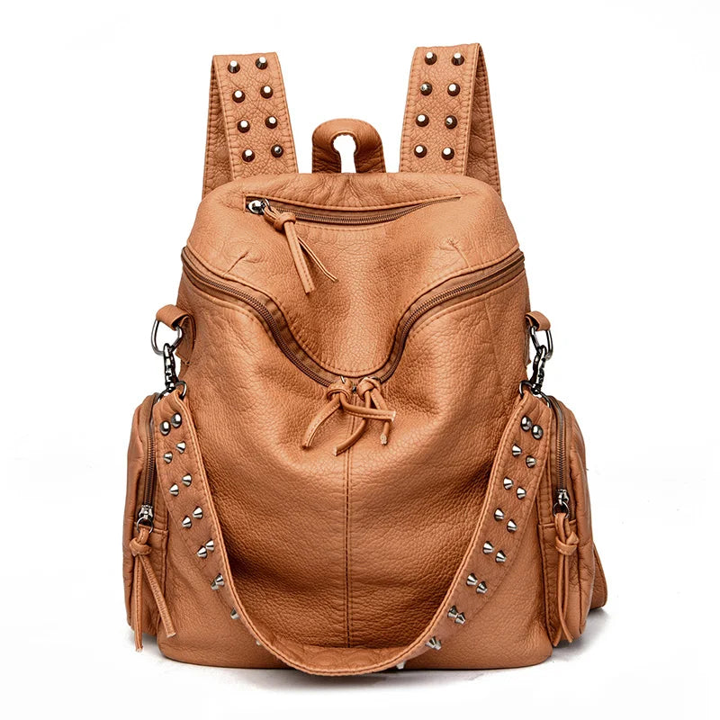A tan leather backpack featuring rivets and straps, shown from the back.