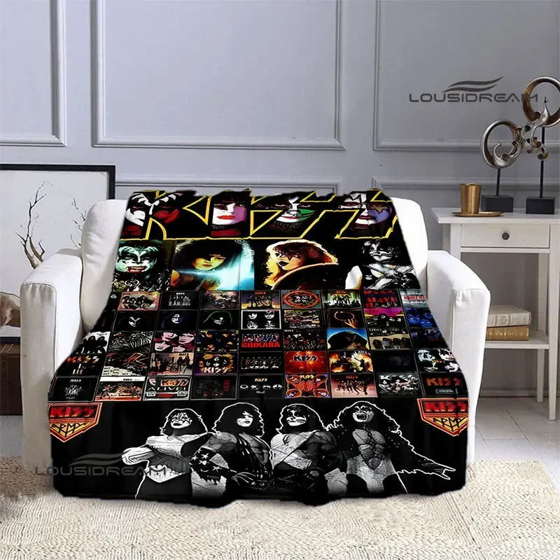 A black flannel throw blanket featuring various iconic band artwork and logos.