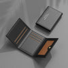 A black leather card holder wallet with multiple slots is shown open on a gray surface.
