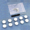 A collection of silver instant no-sew snap buttons is displayed on a translucent plastic sheet.