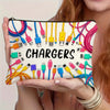 A hand holds a pouch filled with various colorful charging cables and power adapters.