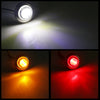 Four round LED side marker lights illuminating a bright beam against a dark background.