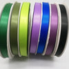 A collection of double face satin ribbons in various solid colors, including green, olive, lime, purple, blue, and black.