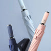 A set of classic business colored umbrellas, including blue and pink, displayed in a box.