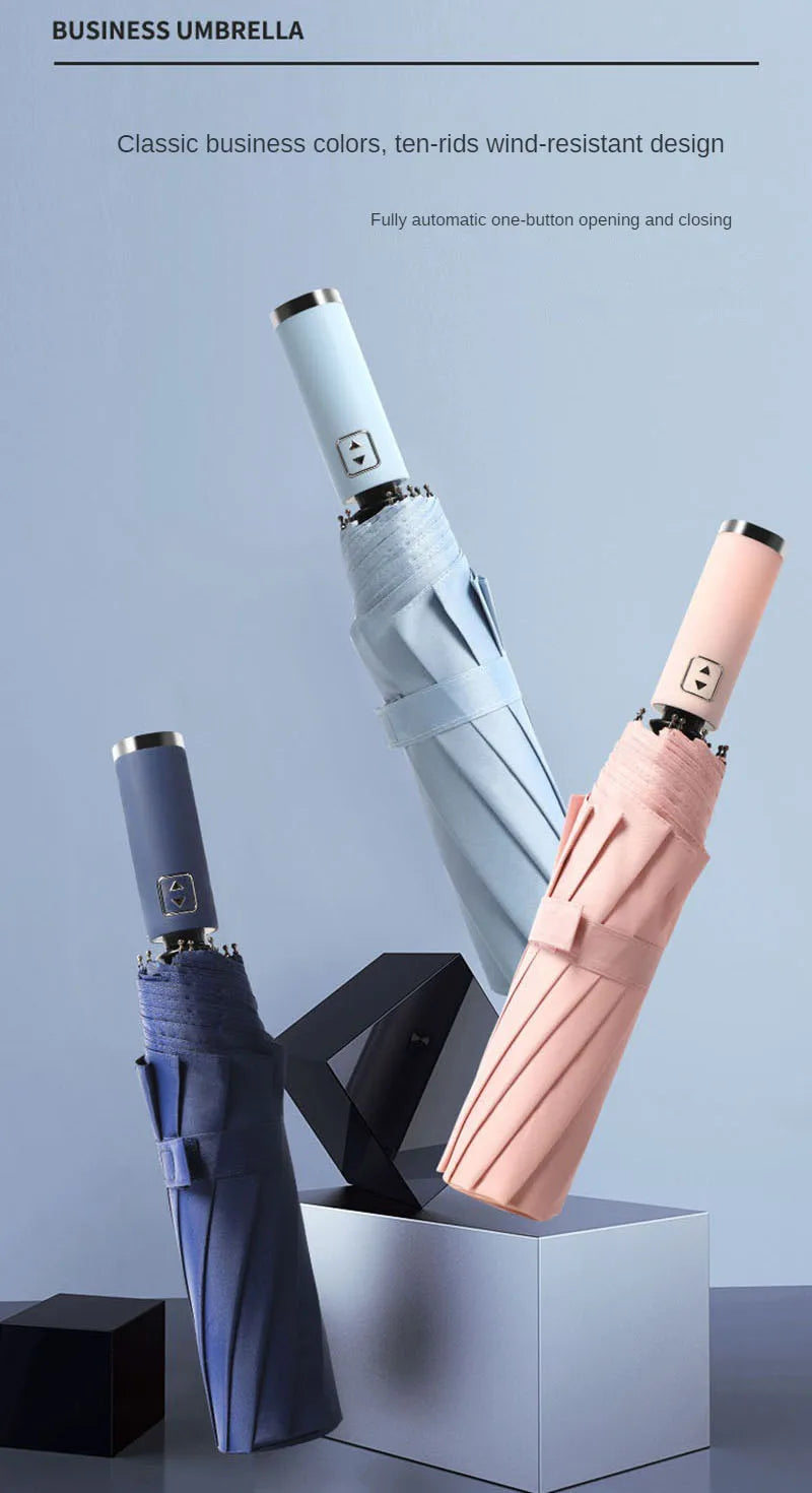 A set of classic business colored umbrellas, including blue and pink, displayed in a box.