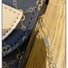 Close-up of a navy blue textured crossbody bag featuring gold chain detailing and a light tan leather flap.