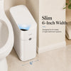 A white slim trash can with a motion sensor is shown next to a toilet, highlighting its 6-inch width.