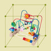A wooden bead maze roller coaster toy featuring colorful beads and an abacus counter, set within a green grid.