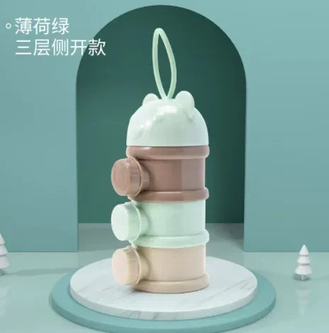 A stack of three light green and beige bear-shaped baby food storage containers.