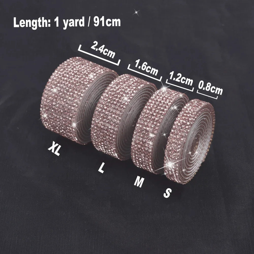 Rolls of crystal rhinestone ribbon stickers in various sizes XL to S displayed on a dark surface.