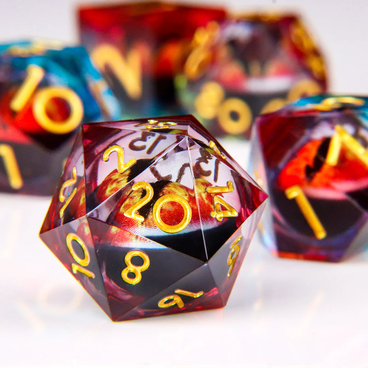 A close-up of a set of liquid core resin dice with dragon eye designs, showing various colors and angles.