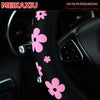 Pink floral patterned steering wheel cover for a car interior.