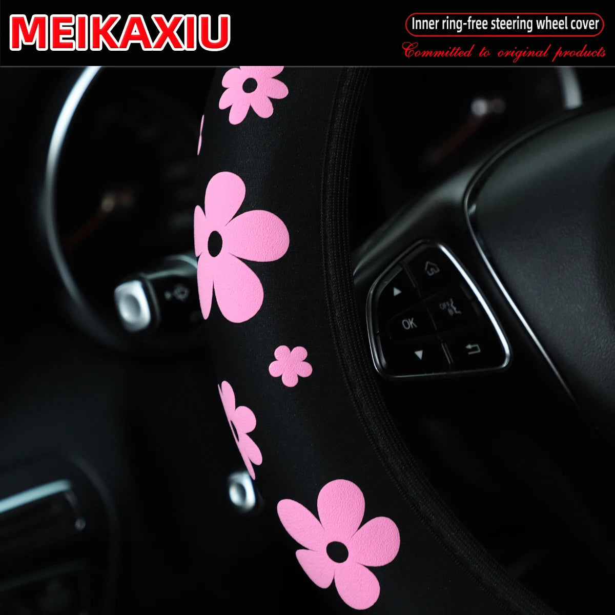 Pink floral patterned steering wheel cover for a car interior.