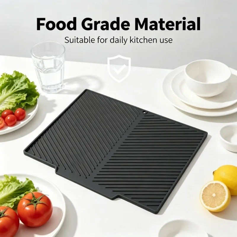 Black silicone dish drying mat and heat-resistant countertop protector shown next to fresh produce.