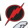 A black circular patch with a red lightning bolt design on a white background.