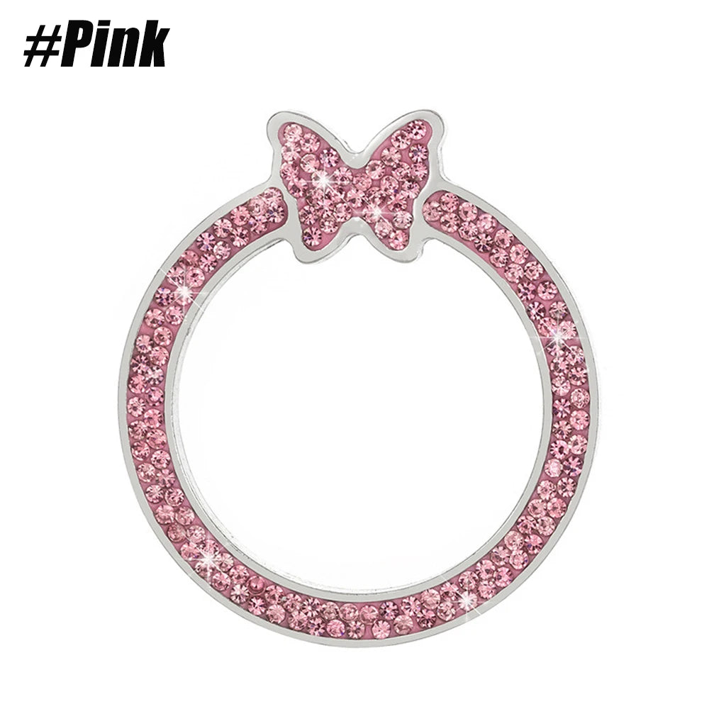 A silver ring with a pink butterfly design encrusted with sparkling rhinestones.