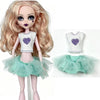 A fashion doll wearing a white top with a purple heart and a sheer mint green tutu skirt.