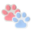 A white silicone cat paw squeeze toy with pink and blue pads for stress relief and fidgeting.