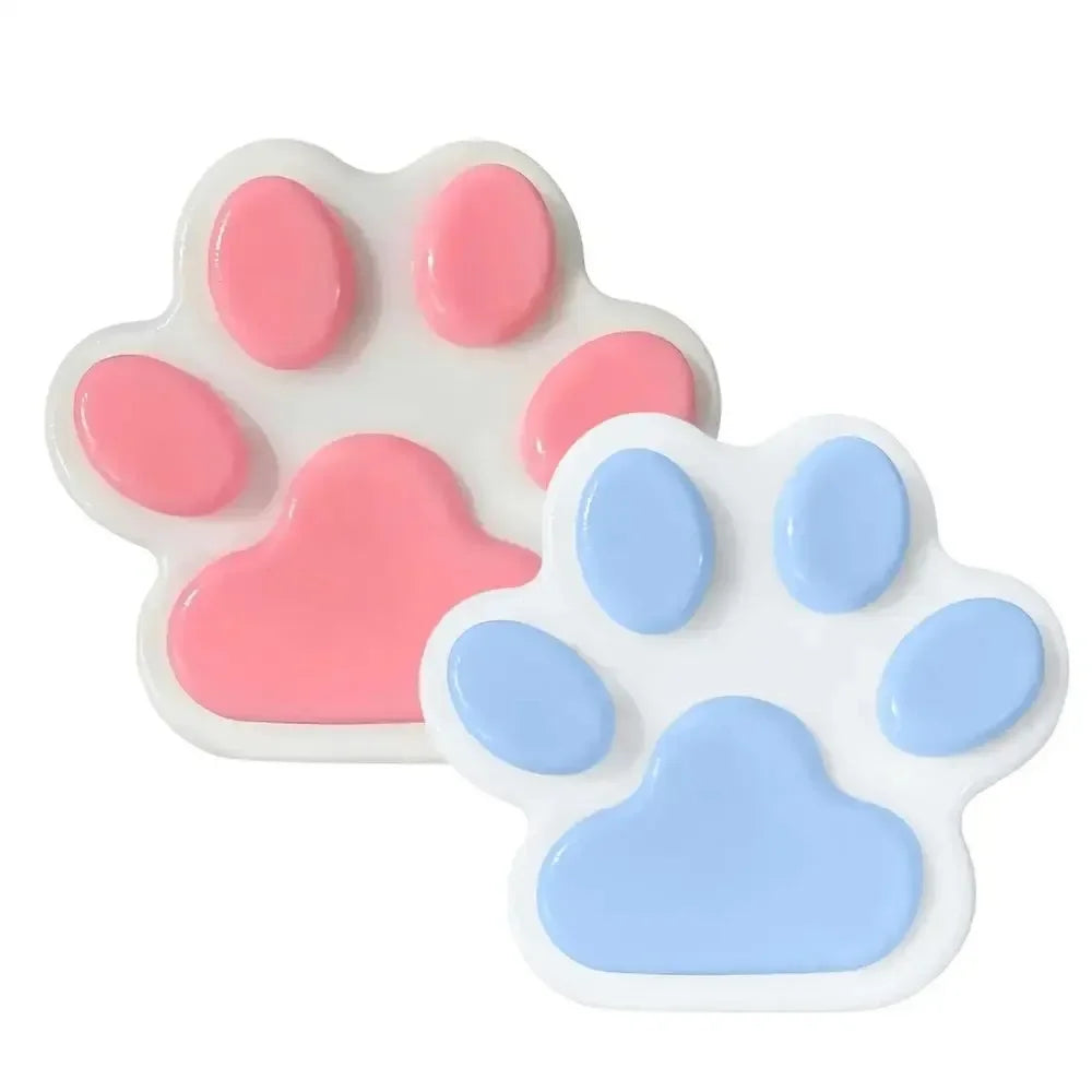A white silicone cat paw squeeze toy with pink and blue pads for stress relief and fidgeting.