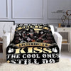A black and gold printed flannel throw blanket featuring the Kiss band members and text.