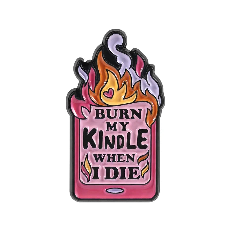 A pink enamel pin featuring a stylized flame design with the text Burn My Kindle When I Die