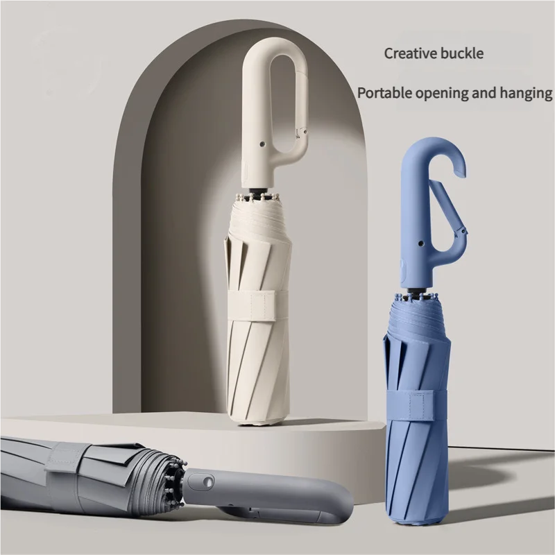A light blue fully automatic windproof folding umbrella is shown standing in an arched niche next to a closed umbrella and an