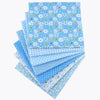 A bundle of light blue cotton fabric squares featuring a floral dot pattern for patchwork and quilting.