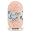 A ball of pink milk cotton blend yarn for knitting and crochet projects.