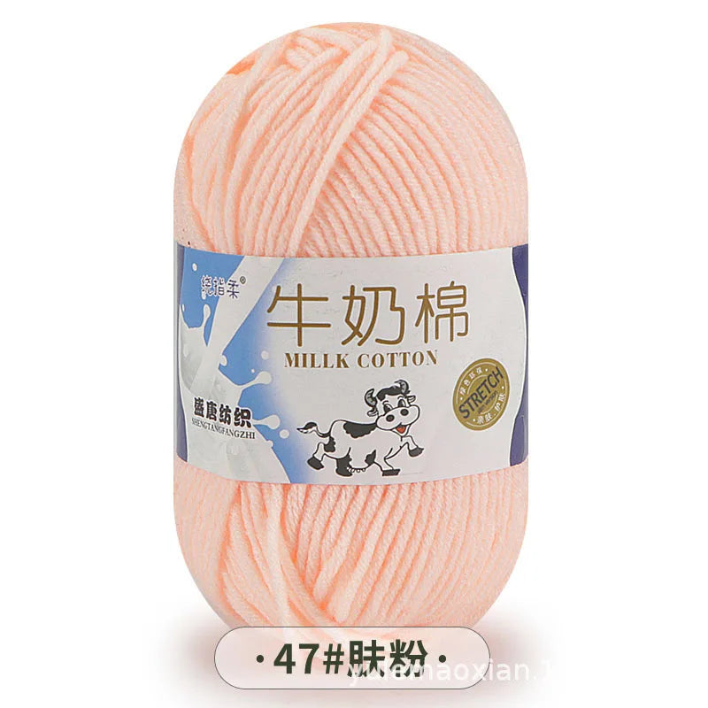 A ball of pink milk cotton blend yarn for knitting and crochet projects.