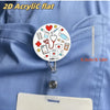 A round acrylic badge holder featuring medical symbols like a heart stethoscope and first aid kit attached to a clip.