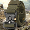 A close-up of a dark olive green tactical nylon belt with a secure metal buckle lying on rocky terrain.